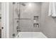Modern bathroom features a bathtub, stylish gray tiles, and shower with glass paneling at 2991 Windfield Cir, Tucker, GA 30084