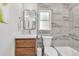 Modern bathroom features stylish marble tiles, a sink, a toilet, and a bathtub at 2991 Windfield Cir, Tucker, GA 30084