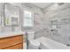 Modern bathroom features stylish marble tiles, a sink, a toilet, and a bathtub at 2991 Windfield Cir, Tucker, GA 30084