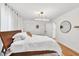 Elegant bedroom with hardwood flooring, a plush bed, and a minimalist aesthetic at 2991 Windfield Cir, Tucker, GA 30084