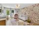 Charming Bedroom features stylish wallpaper, a white crib, a chair, and a large window at 2991 Windfield Cir, Tucker, GA 30084
