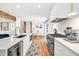 Bright white kitchen with modern stainless steel appliances and quartz countertops overlooking the breakfast area at 2991 Windfield Cir, Tucker, GA 30084
