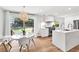 Bright kitchen and dining area with modern appliances, quartz countertops and view of backyard through sliding doors at 2991 Windfield Cir, Tucker, GA 30084