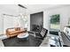 Modern living room with a black brick fireplace, a piano, and elegant decor providing an inviting space at 2991 Windfield Cir, Tucker, GA 30084