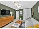 Modern living room featuring olive green walls, hardwood floors, and stylish furniture at 2991 Windfield Cir, Tucker, GA 30084