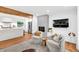 Open living room connecting to the kitchen featuring hardwood floors, modern decor, and cozy seating at 2991 Windfield Cir, Tucker, GA 30084