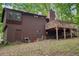 Side of the home featuring a brown exterior, a deck, and a door to the backyard at 3679 Regent Nw Dr, Kennesaw, GA 30144