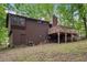 Wood-sided home features a wooden deck, stairs and a lush wooded lot at 3679 Regent Nw Dr, Kennesaw, GA 30144