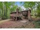Back exterior featuring a deck, stairs and steps down to a backyard, enclosed by wood fence at 3679 Regent Nw Dr, Kennesaw, GA 30144