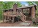View of the home's back exterior including a wooden deck, stairs, and some backyard at 3679 Regent Nw Dr, Kennesaw, GA 30144