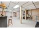 This finished basement features concrete floors, a bar area, and overhead tile lighting at 3679 Regent Nw Dr, Kennesaw, GA 30144