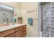 This bathroom has a large mirror, a vanity with storage, and a shower with curtain at 3679 Regent Nw Dr, Kennesaw, GA 30144