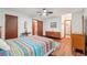 Light-filled bedroom with wood floors, a ceiling fan, and ample space for furniture at 3679 Regent Nw Dr, Kennesaw, GA 30144