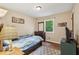 This bedroom boasts a decorative rug, wood floors, and a dresser beneath a window at 3679 Regent Nw Dr, Kennesaw, GA 30144