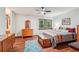 Charming bedroom with wood floors, a window view, and a vintage-style dresser at 3679 Regent Nw Dr, Kennesaw, GA 30144