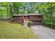 Charming two-story home with an orange door, lush landscaping, and a two car garage at 3679 Regent Nw Dr, Kennesaw, GA 30144