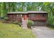 Charming two-story home with an orange door, lush landscaping, and a two car garage at 3679 Regent Nw Dr, Kennesaw, GA 30144