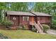 Charming two-story home with an orange door, lush landscaping, and a two car garage at 3679 Regent Nw Dr, Kennesaw, GA 30144