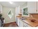 Inviting kitchen with stainless steel sink, diamond window, and butcher block counters at 3679 Regent Nw Dr, Kennesaw, GA 30144