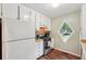 White kitchen with stainless steel appliances and a diamond window at 3679 Regent Nw Dr, Kennesaw, GA 30144