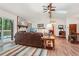 Comfortable living room features a stone fireplace, wood floors, and a sliding door to the deck at 3679 Regent Nw Dr, Kennesaw, GA 30144