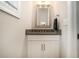 Half bath with vanity and sink, granite countertop, and neutral wall color at 704 Fairlane Dr, Marietta, GA 30064