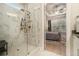 Primary bathroom featuring glass enclosed shower with marble tile, fan and neutral paint at 704 Fairlane Dr, Marietta, GA 30064