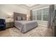 Cozy bedroom featuring a king sized bed, area rug, window, and side tables at 704 Fairlane Dr, Marietta, GA 30064