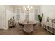 Dining room featuring a round table, chandelier lighting, and decorative wall panels at 704 Fairlane Dr, Marietta, GA 30064