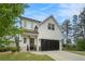 Charming home with well-maintained lawn, a front porch, and an attached two-car garage at 704 Fairlane Dr, Marietta, GA 30064