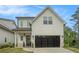 Charming two-story home with a black garage door, a well manicured lawn, and attractive curb appeal at 704 Fairlane Dr, Marietta, GA 30064