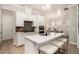 Bright kitchen boasts white cabinets, quartz counters, stainless appliances, and a center island at 704 Fairlane Dr, Marietta, GA 30064