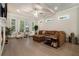 Spacious living room featuring hardwood floors, comfortable seating, lots of natural light and a ceiling fan at 704 Fairlane Dr, Marietta, GA 30064