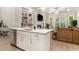 Open concept kitchen and living room featuring a fireplace, built-in shelves, and a large sofa at 704 Fairlane Dr, Marietta, GA 30064