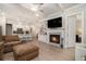 Open concept living room with fireplace, kitchen, hardwood floors, and a ceiling fan at 704 Fairlane Dr, Marietta, GA 30064