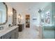 Bright bathroom features dual vanities, soaking tub, herringbone floors, and walk-in closet at 777 Brookridge Ne Dr, Atlanta, GA 30306
