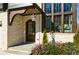 Beautiful stone entrance with arched wood door, elegant lantern and meticulously landscaped flower beds at 777 Brookridge Ne Dr, Atlanta, GA 30306