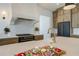 Close-up of kitchen island with charcuterie board, range, and gourmet style faucet at 777 Brookridge Ne Dr, Atlanta, GA 30306