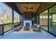 Inviting covered deck with comfortable seating, fireplace, ceiling fan, and scenic views at 777 Brookridge Ne Dr, Atlanta, GA 30306