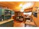 Quaint kitchen with wood paneled ceiling and walls, stove, table and chairs, and built-in shelving at 20 Mahan Ne Ln, Rydal, GA 30171