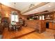 Rustic kitchen featuring wood log decor, wood floors, appliances, and an eat-in dining area at 20 Mahan Ne Ln, Rydal, GA 30171