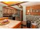Rustic laundry room with stone accent wall and modern washer and dryer at 20 Mahan Ne Ln, Rydal, GA 30171
