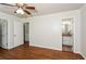 Spacious bedroom featuring hardwood floors, a ceiling fan, and access to the bathroom at 2636 Suzanne Ln, Acworth, GA 30102