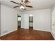 Spacious bedroom featuring hardwood floors, a ceiling fan, and access to the bathroom at 2636 Suzanne Ln, Acworth, GA 30102