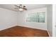 Bedroom with hardwood floors, white trim, ceiling fan, and large window at 2636 Suzanne Ln, Acworth, GA 30102