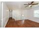 Bright hallway featuring wood floors, white railing, and a classic ceiling fan at 2636 Suzanne Ln, Acworth, GA 30102