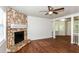 Cozy living room featuring a stone fireplace, hardwood flooring, and bay windows at 2636 Suzanne Ln, Acworth, GA 30102