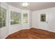 Bright sunroom featuring hardwood flooring, large windows, and a door to the exterior at 2636 Suzanne Ln, Acworth, GA 30102