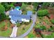 Aerial view of home with pool, long driveway and manicured landscaping at 3109 Country Lake Dr, Powder Springs, GA 30127