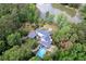 Aerial view of home and property showcasing a swimming pool and lush landscaping at 3109 Country Lake Dr, Powder Springs, GA 30127